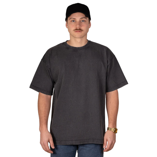 Person wearing a plain black t-shirt and black cap on a light gray background