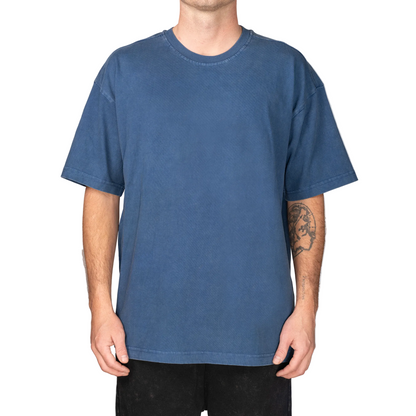 Person wearing a blue t-shirt against a gray background