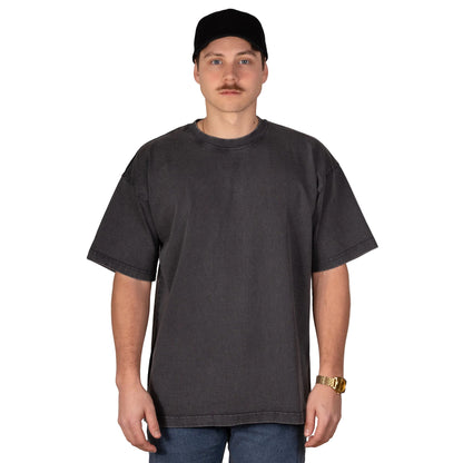 Person wearing a plain black t-shirt and black cap on a light gray background