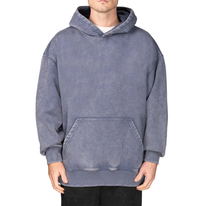 Person wearing a gray hoodie on a plain background
